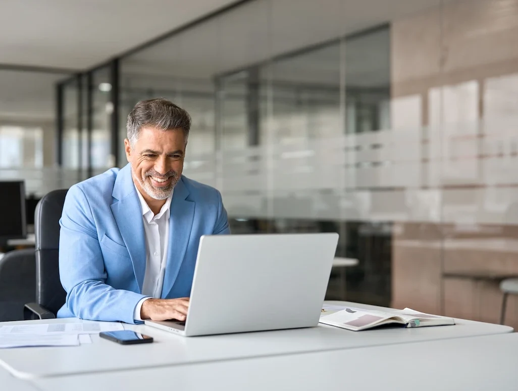 Businessman using laptop to read reviews